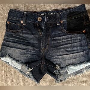 Dark wash American eagle cutoffs.